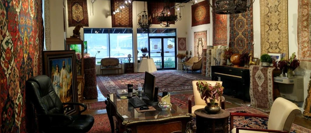 Elegant room filled with intricately patterned rugs hanging on walls and floors
